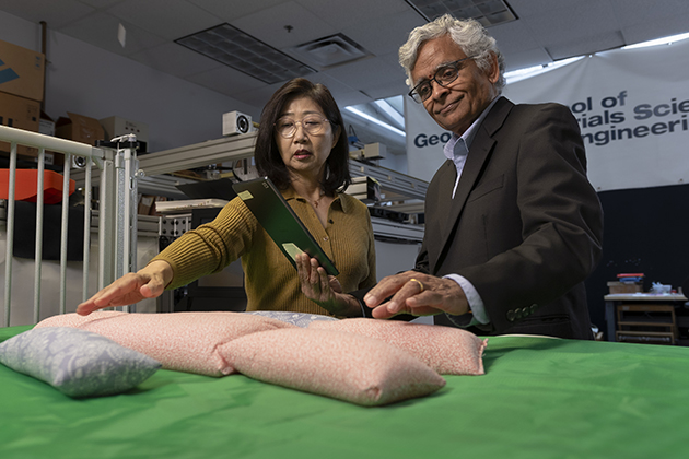 Researchers Sungmee Park and Sundaresan Jayaraman show a prototype of the pressure‑sensing fabric in the lab.